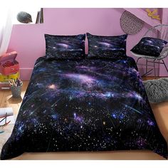 a bed covered in a black and purple space themed comforter