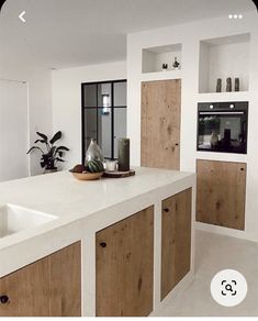 an instagram photo of a kitchen with white counter tops and wooden cabinets, along with the words instagram above it