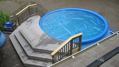 an above ground swimming pool with steps leading up to it and a blue plastic liner in the middle