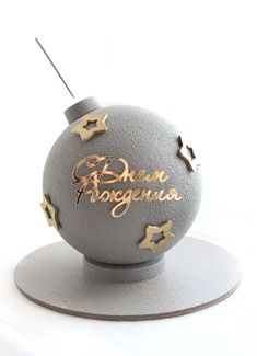 an ornament with the words born to argentina on it and some gold stars