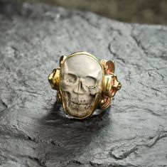 Discover the allure of the Carved Skull Ring, featuring hand-carved human skulls in Horn, Bone and Jasper. Set in our traditional Sylvan Band with intricate floral motifs and mini skulls on the edges, this limited-edition vintage piece won't be restocked-ideal for collectors seeking bold, one-of-a kind designs. Human Skull, Skull Carving, Skull Ring, Ring Finger, Floral Motif, Bones, Hand Carved, Carving, Band