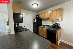 an empty kitchen with black appliances and wood cabinets in the back drop off from the living room