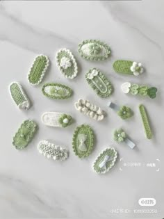 crocheted green and white items are arranged on a marble surface