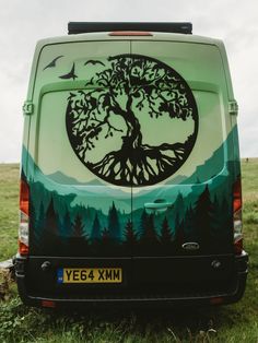 a van with a tree painted on it's side and the words, a spectacular campervan convention that turns heads