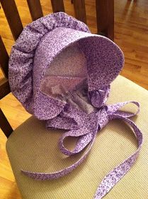 a purple bonnet sitting on top of a chair