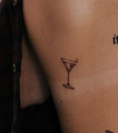 a tattoo on the back of a man's shoulder that reads, i drink it