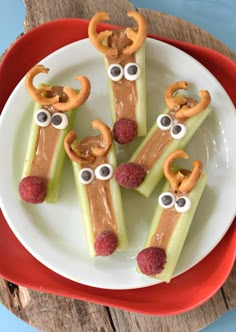 some food on a plate with eyes and pretzels in the shape of characters