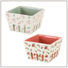 two white and pink flowered ceramic containers with red trimmings on the sides