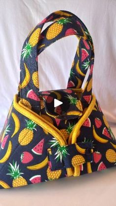 a purse with pineapples and bananas on it