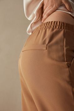 Full-length trousers featuring two pockets, faux back pocket and covered elasticated waist. Stretch Pants With Pockets For Business Casual, Versatile Business Casual Pants With Elastic Waistband, Trousers With Pockets For Everyday, Elegant Tapered Leg Bottoms For Everyday, Everyday Trousers With Pockets, Elegant Ankle-length Pants For Everyday, Stretch Workwear Pants With Elastic Cuffs, Chic Everyday Pants With Elastic Waistband, Versatile Pants With Elastic Waistband For Work