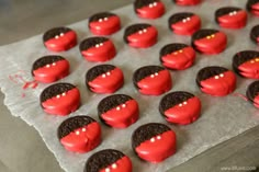 red and black heart shaped cookies are on a piece of paper