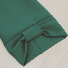 a close up of a green cloth on a wooden surface