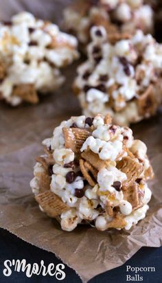 popcorn balls with chocolate chips and marshmallows are on top of brown paper