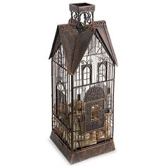 a birdcage filled with lots of gold coins on top of a white surface