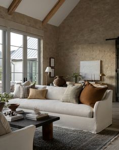 a living room filled with furniture and lots of windows