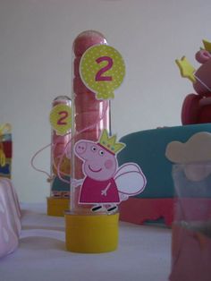 peppa pig birthday candles are on the table next to other party supplies and decorations