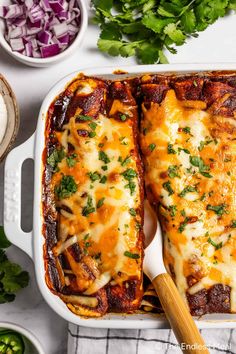 two enchiladas in a white casserole dish