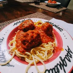 spaghetti and meatballs are on a plate with the words happy birthday written on it