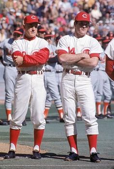 two baseball players standing next to each other in front of a large group of people