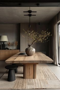 a large wooden table with a vase on it