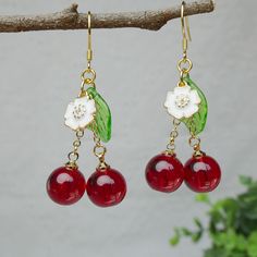 Cherish someone you love, sweet love, pretty girl and vitality are the symbolic meanings of the cherry. Purity and peace are the meanings of this little white flower. These cherry earrings bring sincere blessings to you, either for your own use or as a gift for someone you love. May these earrings brighten up your life. 🙂 All my jewellery is designed and handmade at home. Handmade with love.  🙂 Introducing our stunning handmade earrings, this pair is made from glass cherry, 925 sterling silver hooks, which is hypoallergenic to sensitive skin. The crystallised cherries are wine red colour and very sweet. The overall design is natural and unique, lovely and vibrant. The earrings are brightly coloured and striking for the unique you. Each pair of earrings is carefully handcrafted to ensure Whimsical Red Drop Earrings, Charming Earrings As A Gift, Charming Earrings For Pierced Ears As Gift, Sweet Red Jewelry For Valentine's Day, Trendy Red Earrings For Birthday, Vintage Dangle Flower Earrings For Gift, Retro Flower Earrings For Gift, Trendy Round Flower Earrings For Gift, Trendy Round Flower Earrings As Gift