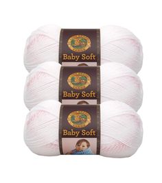 three balls of baby soft yarn in white and pink, with the label on each ball