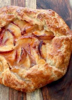 an apple pie on a wooden cutting board