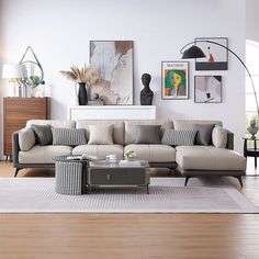 a living room filled with furniture on top of a hard wood floor covered in white walls