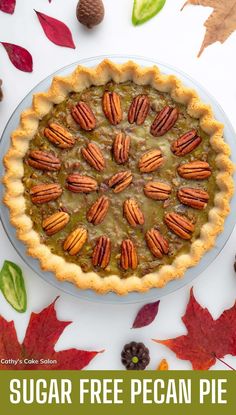 a pie with pecans on top and leaves around it