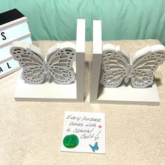 two butterflies are sitting on top of each other next to a sign that says, every purchase comes with a butterfly stamp