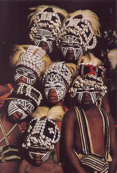 several african people wearing white and black headdresses