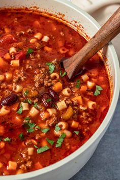 a white bowl filled with chili and pasta soup