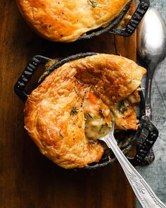 two pot pies sitting on top of a wooden table