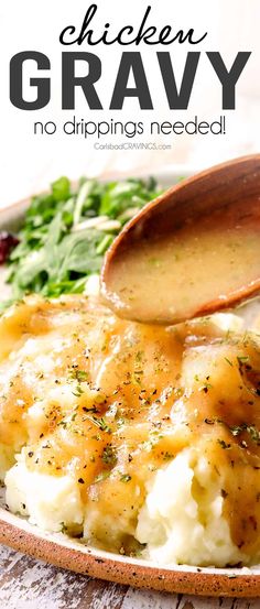 a wooden spoon scooping gravy over mashed potatoes on a white plate