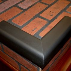 a black leather seat on top of a brick floor