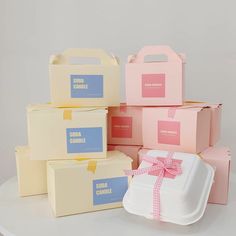 several boxes with bows and labels are stacked on top of each other in different colors