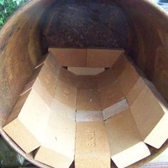 an open cardboard box sitting in the middle of a planter