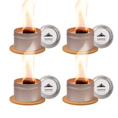 four small tins with lit candles in them