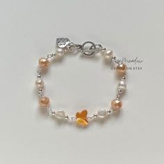 Handmade Dreamy Pearl Bracelet ✿ Made with glass crystal beads, freshwater pearls, and metal accents ✿ Silver, pearl, tangerine, and pale peach white ✿ toggle clasp Beaded Bracelet Aesthetic, Bracelets Preppy, Peach Bracelet, Diy Jewelry Rings, Edgy Jewelry, Orange Bracelet, Bracelets Design, Pale Peach, Pale Orange