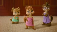 three small figurines of chipmuns dressed up in different colors and sizes