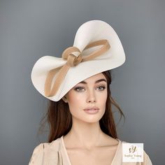 Elegant Ivory and GolD Kentucky derby hat for woman. This cream and camel fascinate hat is embellished with a big bow. It is a perfect hat for weddings, Royal Ascot horse races, cocktails, derby... You can choose the side of the head where you like to wear the fascinator. All my hats are made to order, due to the nature of them, we are do not accept returns or exchanges. Customs and import taxes: Buyers are responsible for any customs and import taxes that may apply. I'm not responsible for delays due to customs. Follow this link for more beautiful choices from 'Sophie Young Hats'  https://www.etsy.com/shop/sophieyounghats Chic Beige Hat With Bow, Chic Structured Crown Fascinator For Church, Elegant Boater Hat With Curved Brim And Bow, Elegant Boater Hat With Bow And Curved Brim, Elegant Boater Hat With Curved Brim And Bow Detail, Chic Headpieces For Kentucky Derby And Formal Events, Formal Summer Hat With Bow, Chic Headpieces For Kentucky Derby, Chic Formal Headpieces For Kentucky Derby