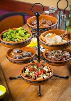 a wooden table topped with bowls filled with different types of food on top of it