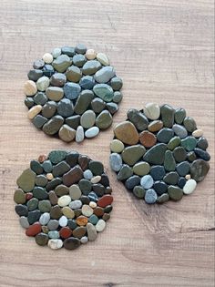 three pieces of rock sitting on top of a wooden table