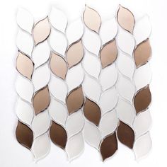 a white and brown mosaic tile pattern on a wall