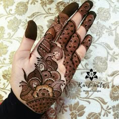 the hand is decorated with henna designs on it