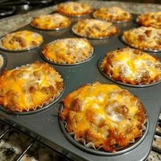 a muffin tin filled with lots of cheese and meat