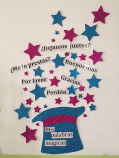 this is an image of a bulletin board with spanish words and stars in the shape of a hat