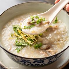 a spoonful of soup in a bowl with parsley on the top and green garnish