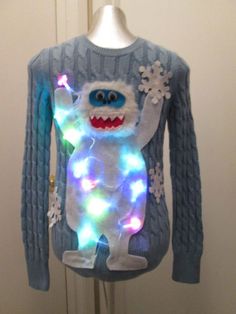 a light up sweater with a monster on it