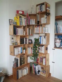 a bookshelf filled with lots of books next to a wall